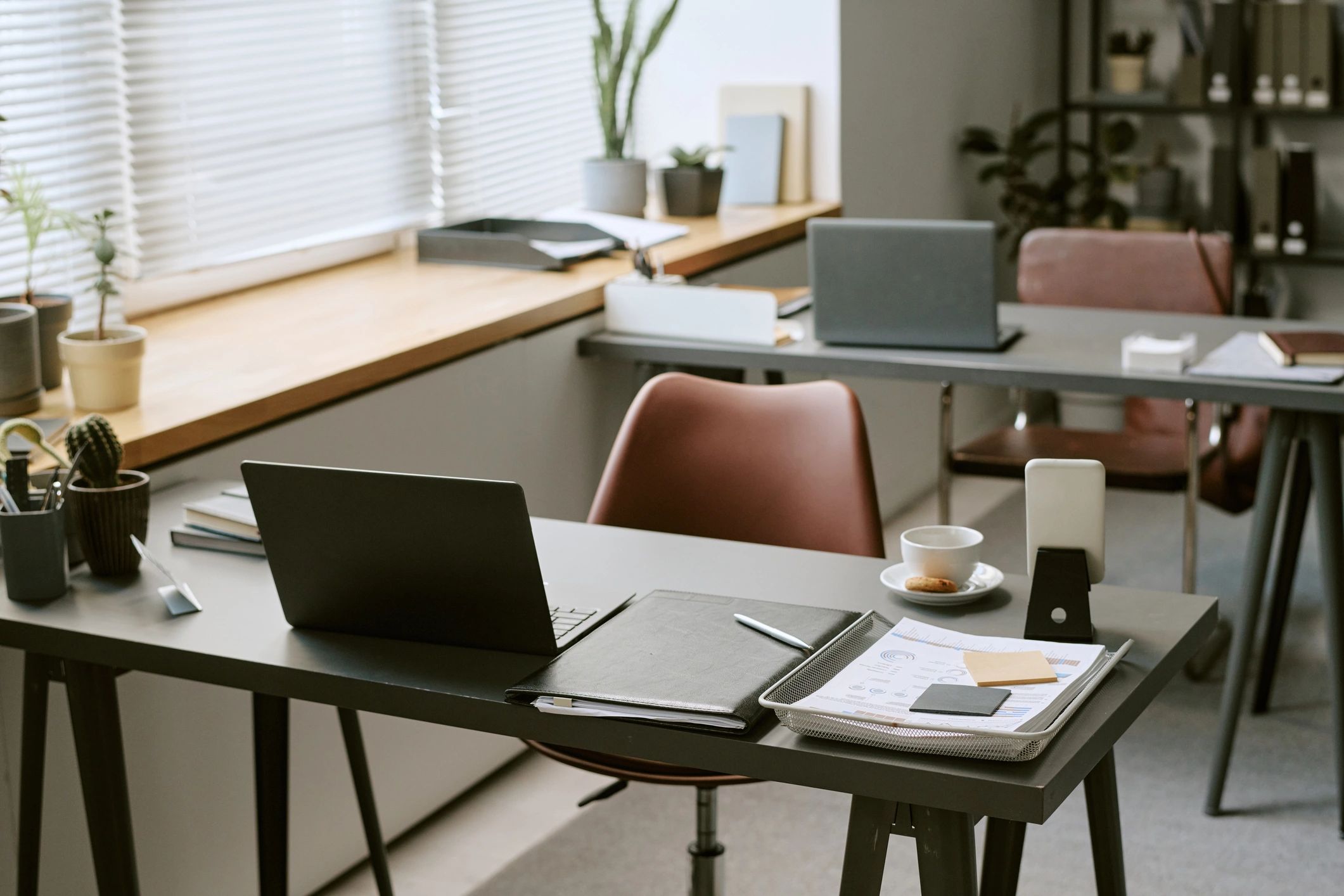 Modern workspace with laptops and documents representing practical AI learning
